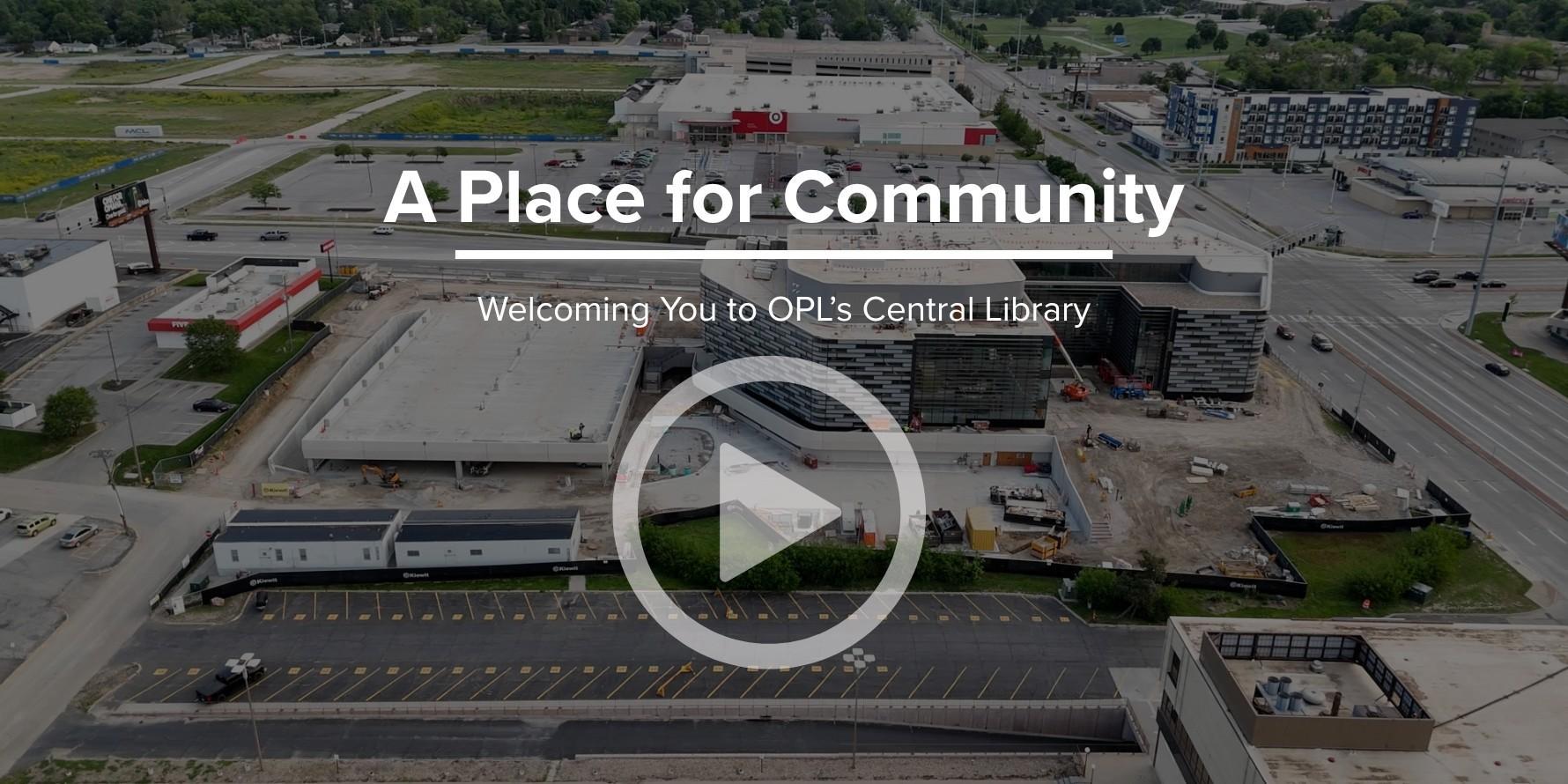 A drone photo of the exterior Central Library building and construction site with a play button and text overlay that reads 