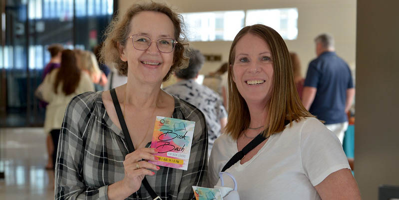 Two adults pose together at the 2026 Book Bash at Central Library.